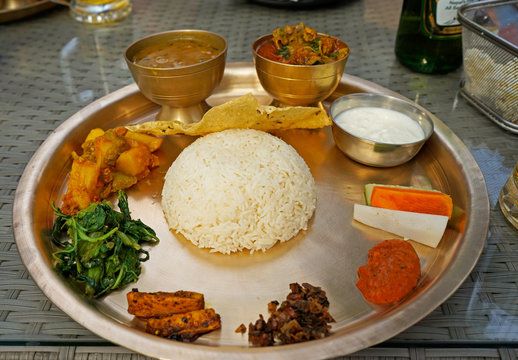Thakali set includes dal bhat and other side dishes that could be vegetable, pickles or meat. It is authentic Nepali cuisine.
